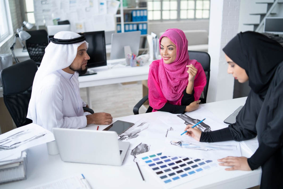 sheikh and girls working in office