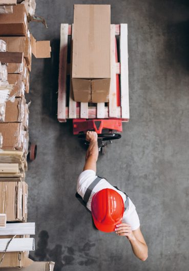 Young man working at a warehouse with boxes